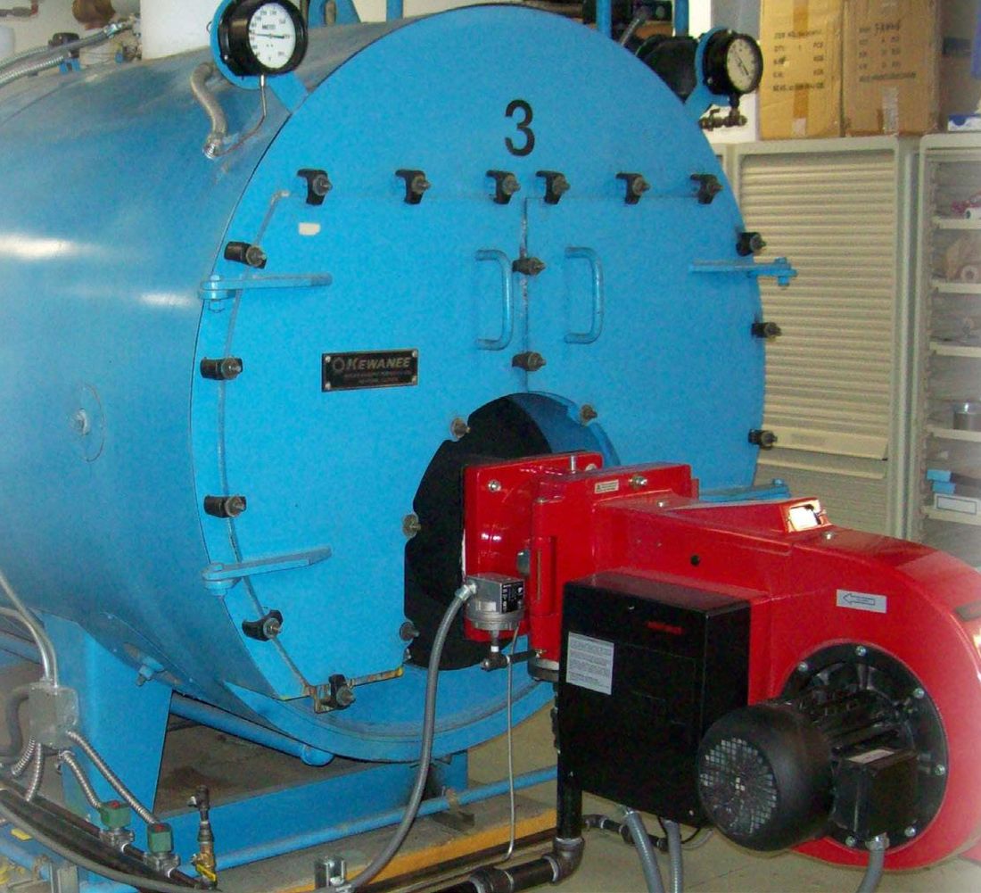 Fire-tube boiler fitted with a red power burner in a mechanical room